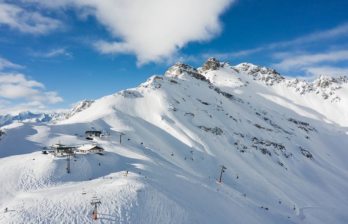 Berggipfel in Schnee bedeckt mit Skipiste 