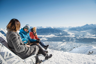 Personen genießen die Sonne auf der Seegruben-Terrasse. Das Skigebiet Nordkette ist im SKI plus CITY Pass Stubai Innsbruck inkludiert.