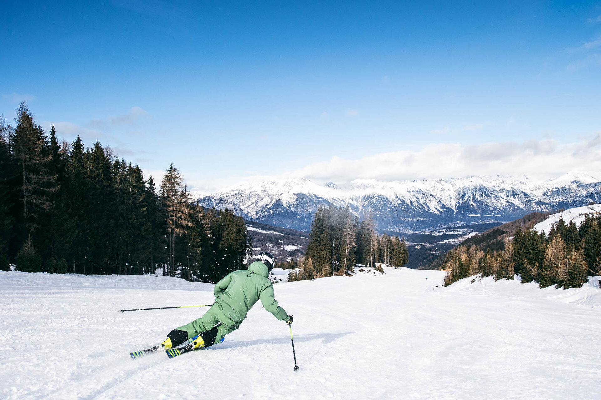 Ein Skifahrer fährt eine Piste hinunter.