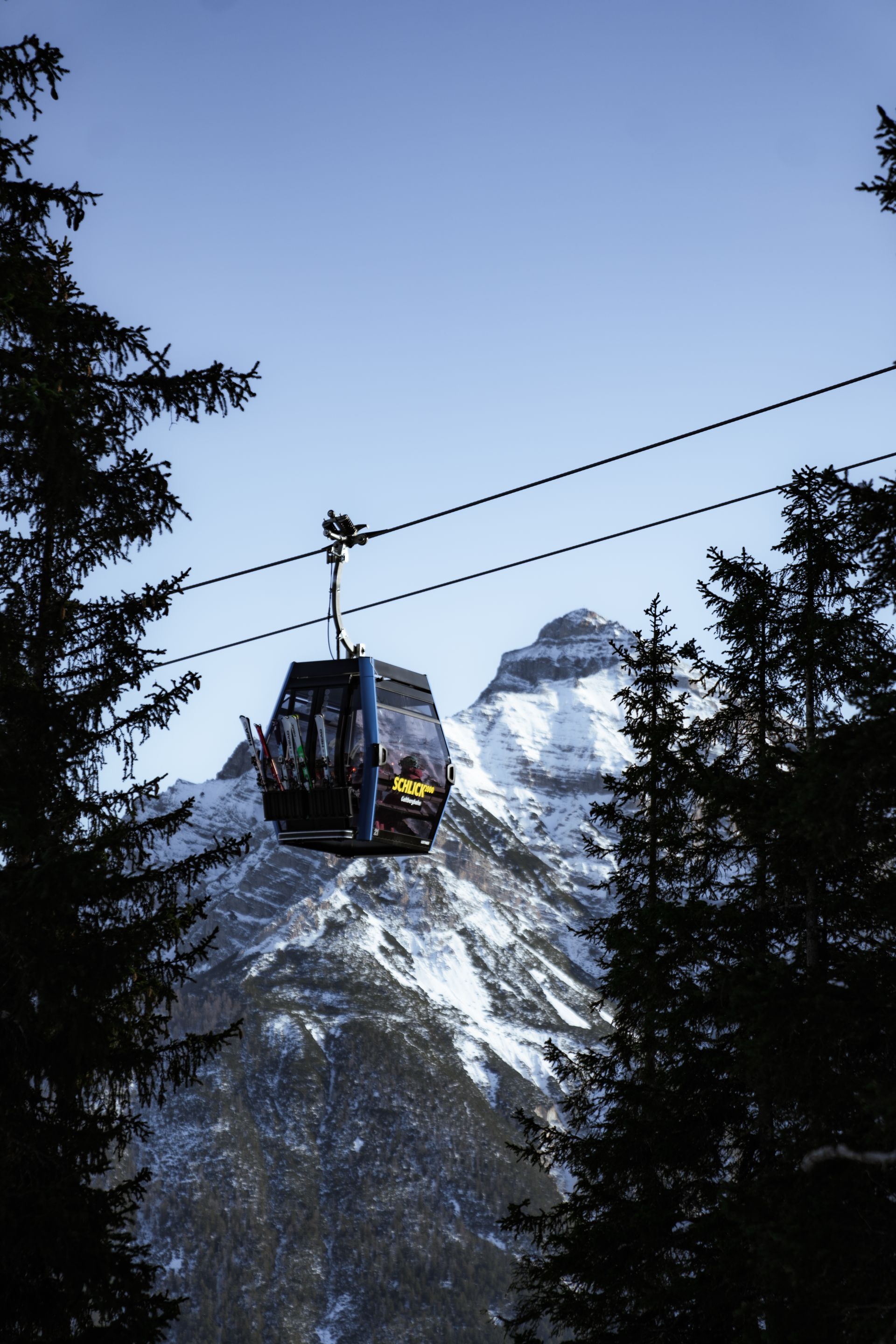 Eine Gondel umgeben von Bergpanorama.